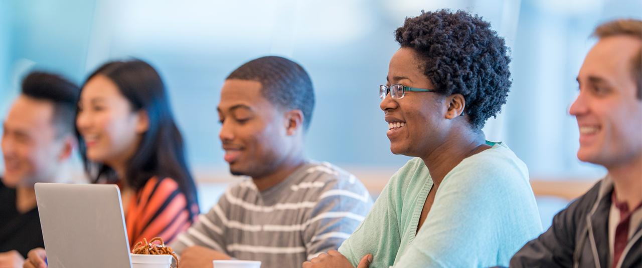 A tablet and open laptop sitting side-by-side on a table with the seacoastbn.com online banking website on both screens