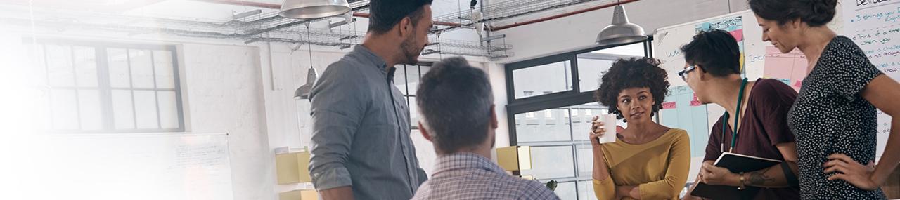 A tablet and open laptop sitting side-by-side on a table with the seacoastbn.com online banking website on both screens